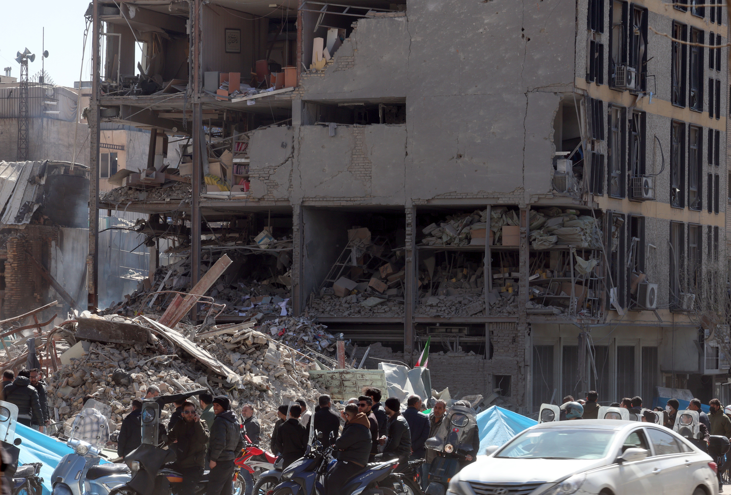 People gather next to a damaged building around Ferdowsi Square after an airstrike in central Tehran, Iran on March 3. [EPA/YONHAP] 