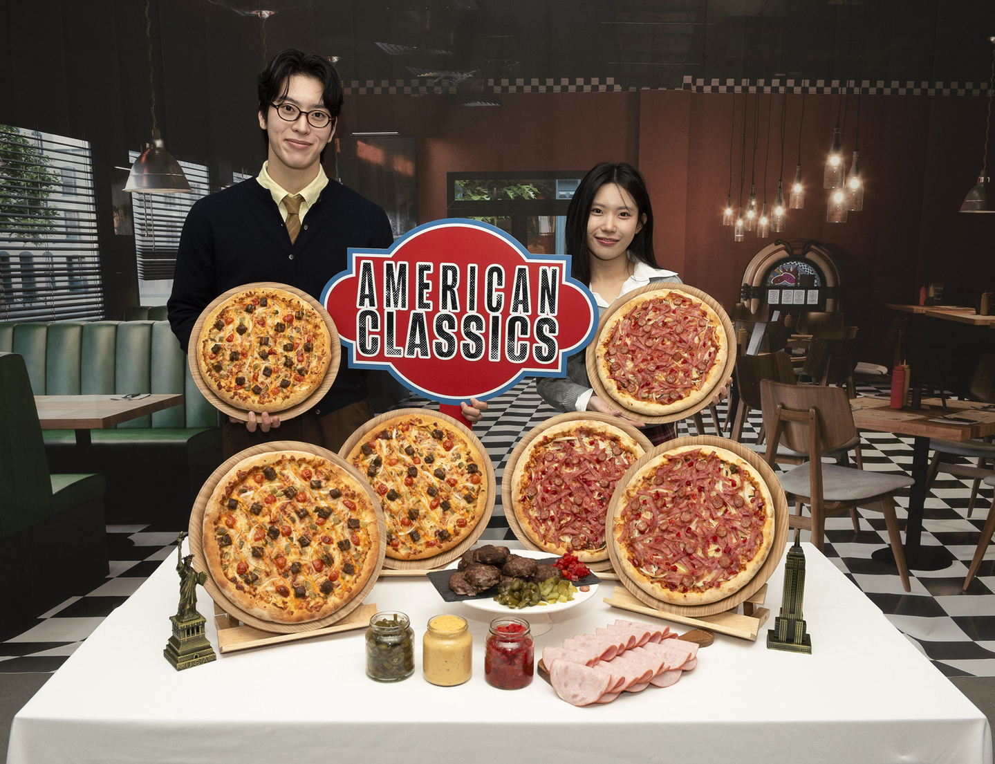 Models pose with Domino’s Pizza’s new “American Classics” pizzas to promote the launch of the products. [DOMINO'S PIZZA]