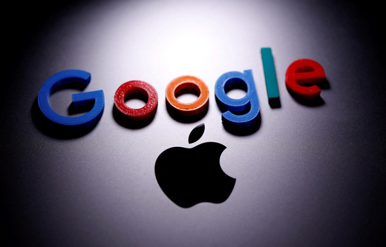 A 3D printed Google logo is placed atop an Apple Macbook in this illustration created on April 12, 2020. [REUTERS/YONHAP]