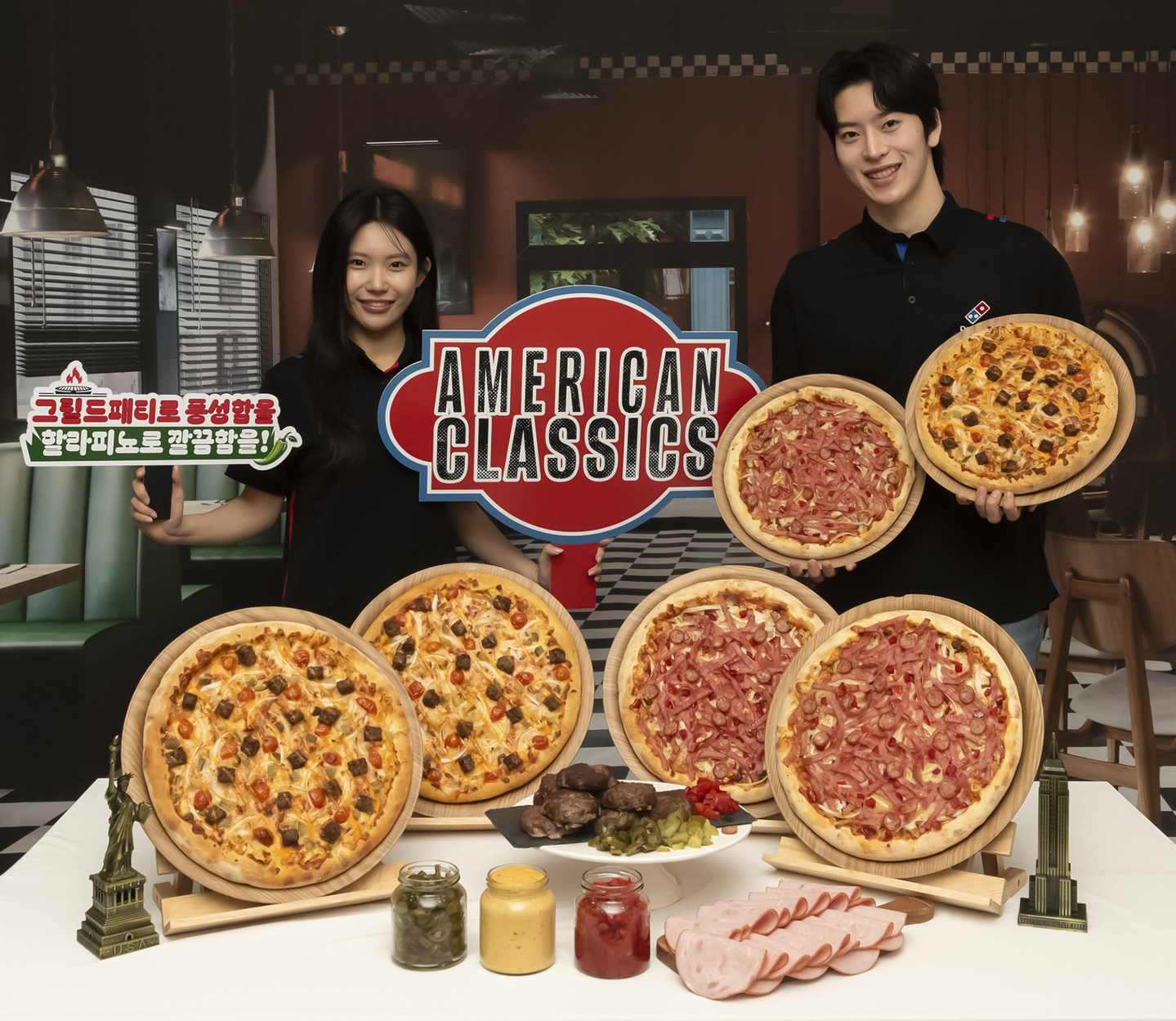 Models pose with Domino’s Pizza’s new “American Classics” pizzas to promote the launch of the products. [DOMINO'S PIZZA]