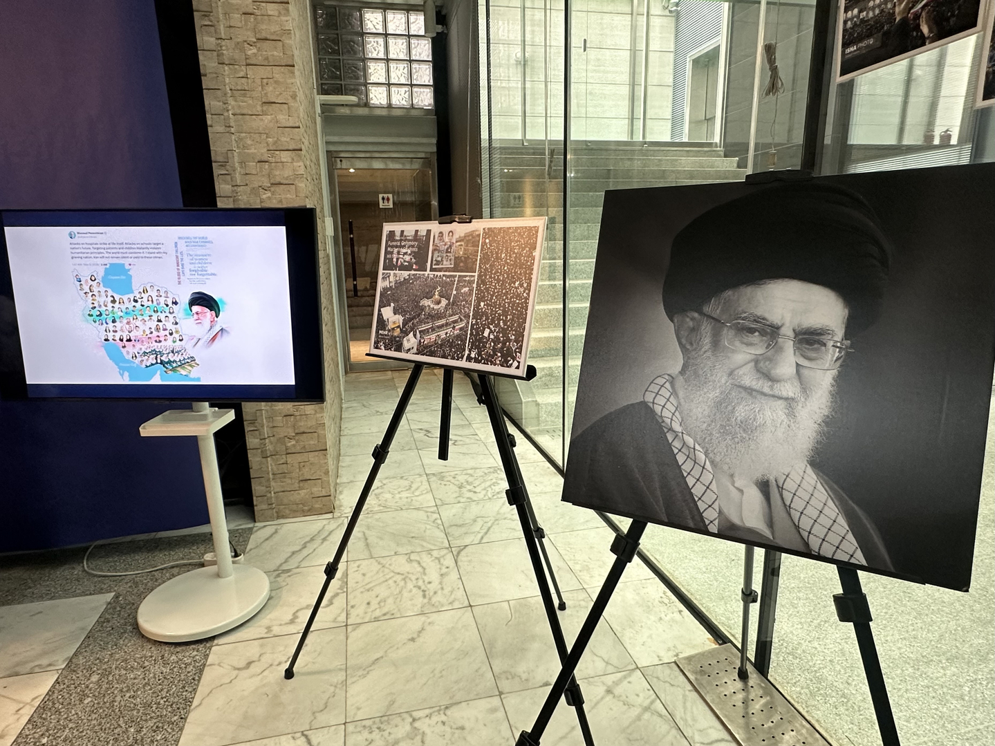 A memorial portrait of Iran’s late supreme leader and photos showing damage from recent airstrikes are displayed at the venue for a press briefing at the Iranian Embassy in Seoul on March 5. [SEO JI-EUN]