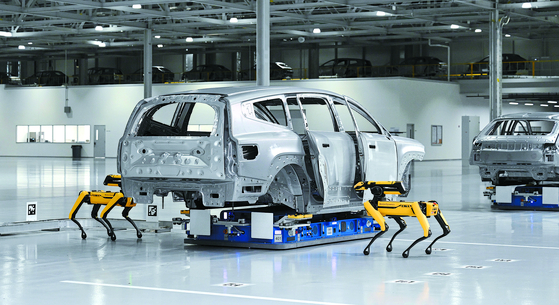 Spot robot dogs, developed by Boston Dynamics, inspect a car at Hyundai Motor Group Metaplant America in Georgia. [HYUNDAI MOTOR]