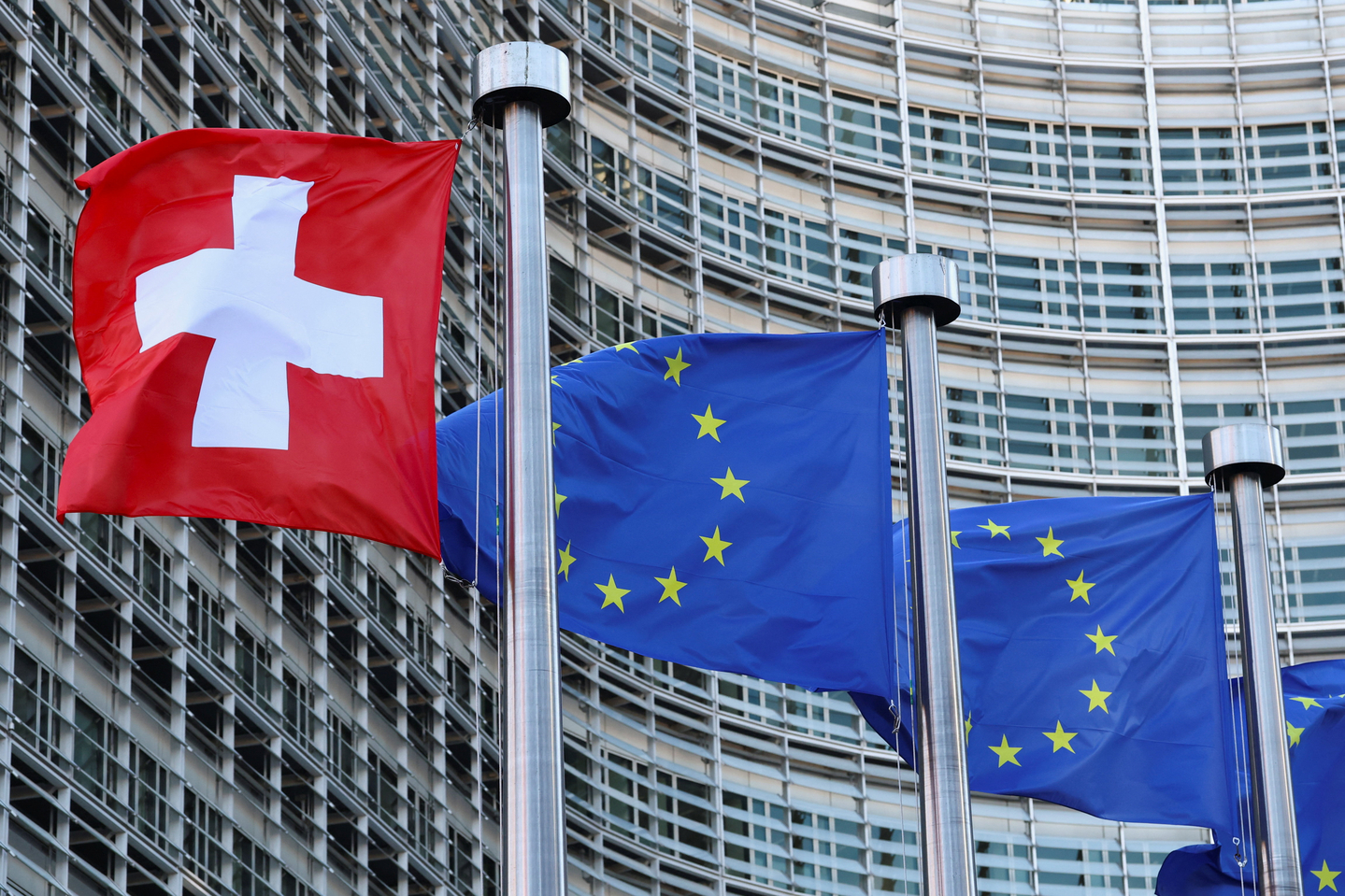 Switzerland's national flag flies beside flags of the European Union in Brussels, Belgium, on March 2. [REUTERS/YONHAP]