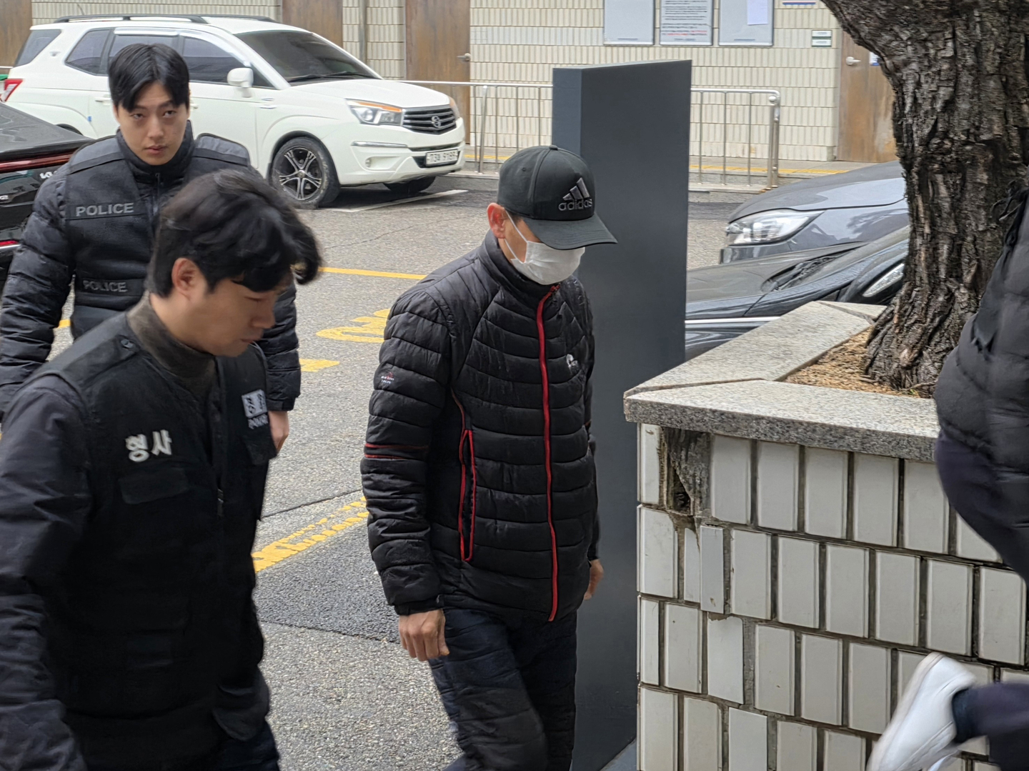 A man who is accused of throwing boiling water on the face of his Thai spouse and causing severe burn injuries is seen at Uijeongbu District Court in Uijeongbu, Gyeonggi, on Dec. 16, 2025. [YONHAP]