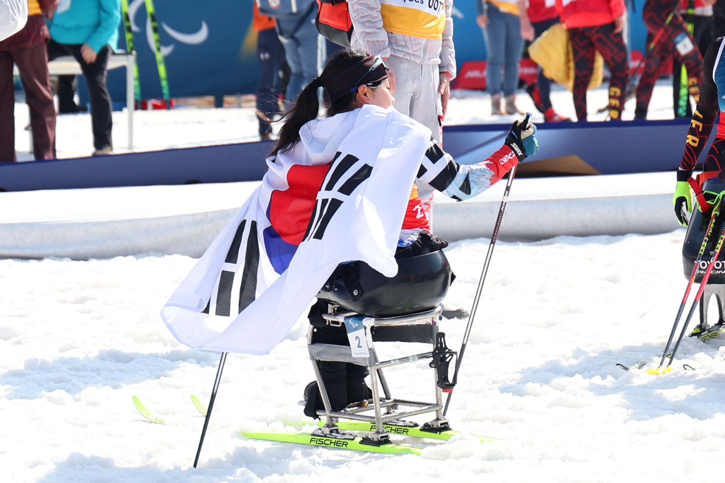 Kim Yun-ji celebrates after winning silver with a time of 33:10.1 in the para cross-country skiing women's sprint sitting at the 2026 Milan-Cortina Winter Paralympics at the Tesero Cross-Country Skiing Stadium in Italy on March 10. [KOREA PARALYMPIC COMMITTEE]