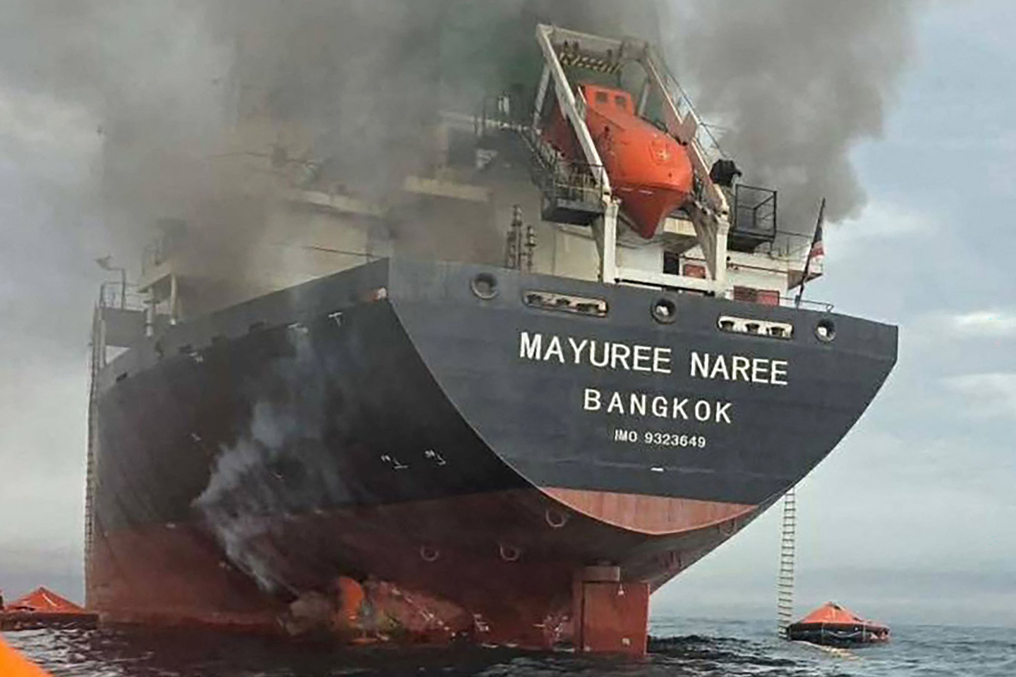 This handout photo taken on March 11 shows smoke rising from the Thai bulk carrier Mayuree Naree near the Strait of Hormuz after an attack. The carrier travelling in the crucial Strait of Hormuz was attacked on March 11, with 20 crew members rescued so far, the Thai Navy said. [ROYAL THAI NAVY]