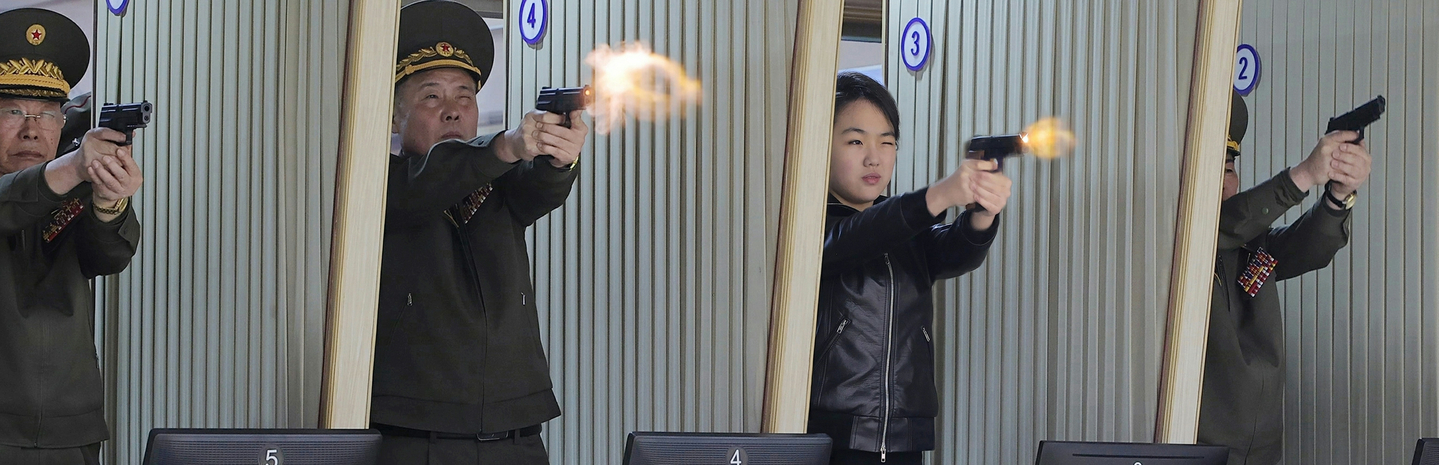 North Korean leader Kim Jong-un's daughter Kim Ju-ae, second from right, fires a pistol at a shooting range on March 11, during an inspection of a factory for light, portable weapons, in this photo published by the Korean Central News Agency on March 12. [YONHAP]