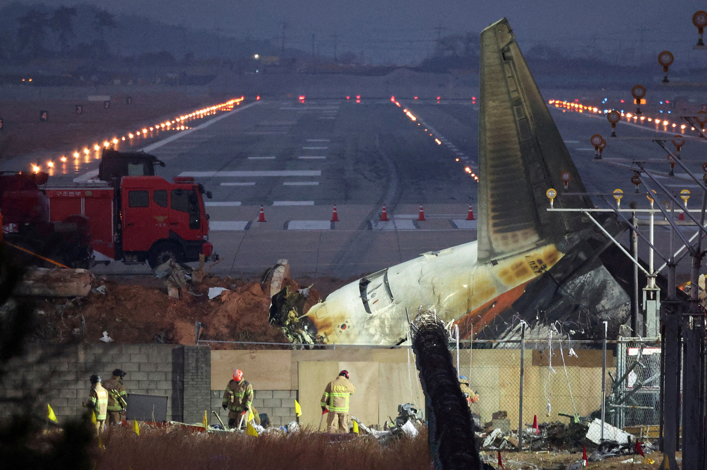 Rescuers work near the wreckage of the Jeju Air aircraft that went off the runway and crashed at Muan International Airport, in Muan, South Jeolla, on Dec. 30, 2024. [REUTERS/YONHAP] 