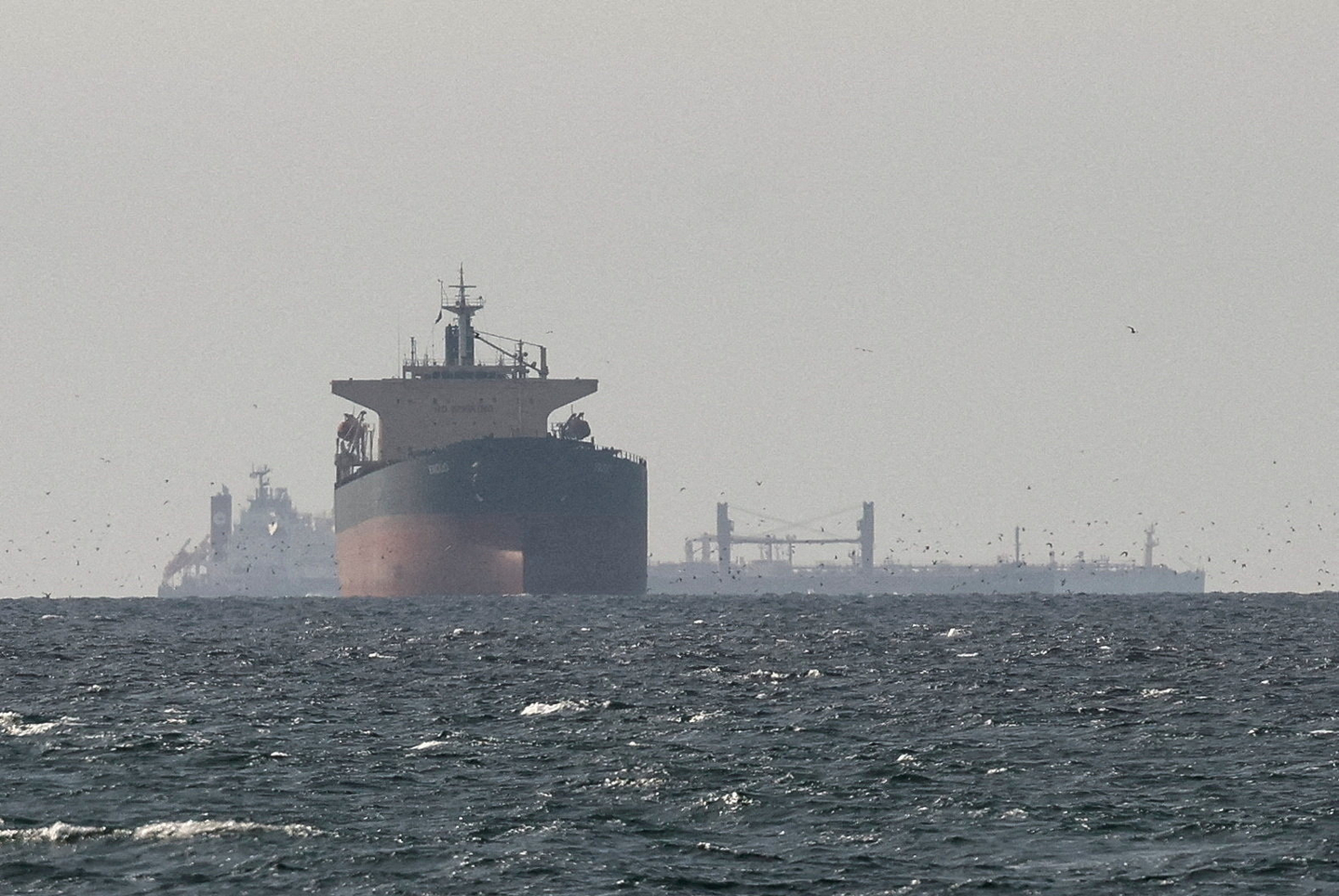 Tankers sail in the Gulf, near the Strait of Hormuz, as seen from northern Ras al-Khaimah, near the border with Oman’s Musandam governance, in the United Arab Emirates on March 11 amid the U.S.-Israeli conflict with Iran. [REUTERS/YONHAP]
