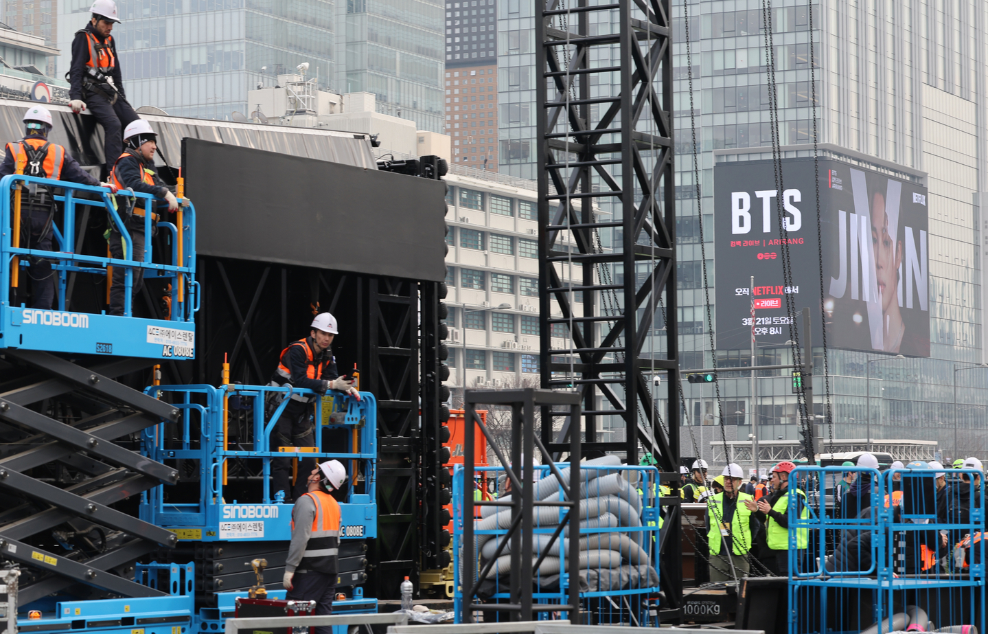 Workers install the stage for the upcoming BTS performance slated for March 21 at Gwanghwamun Square in central Seoul on March 16. [YONHAP]
