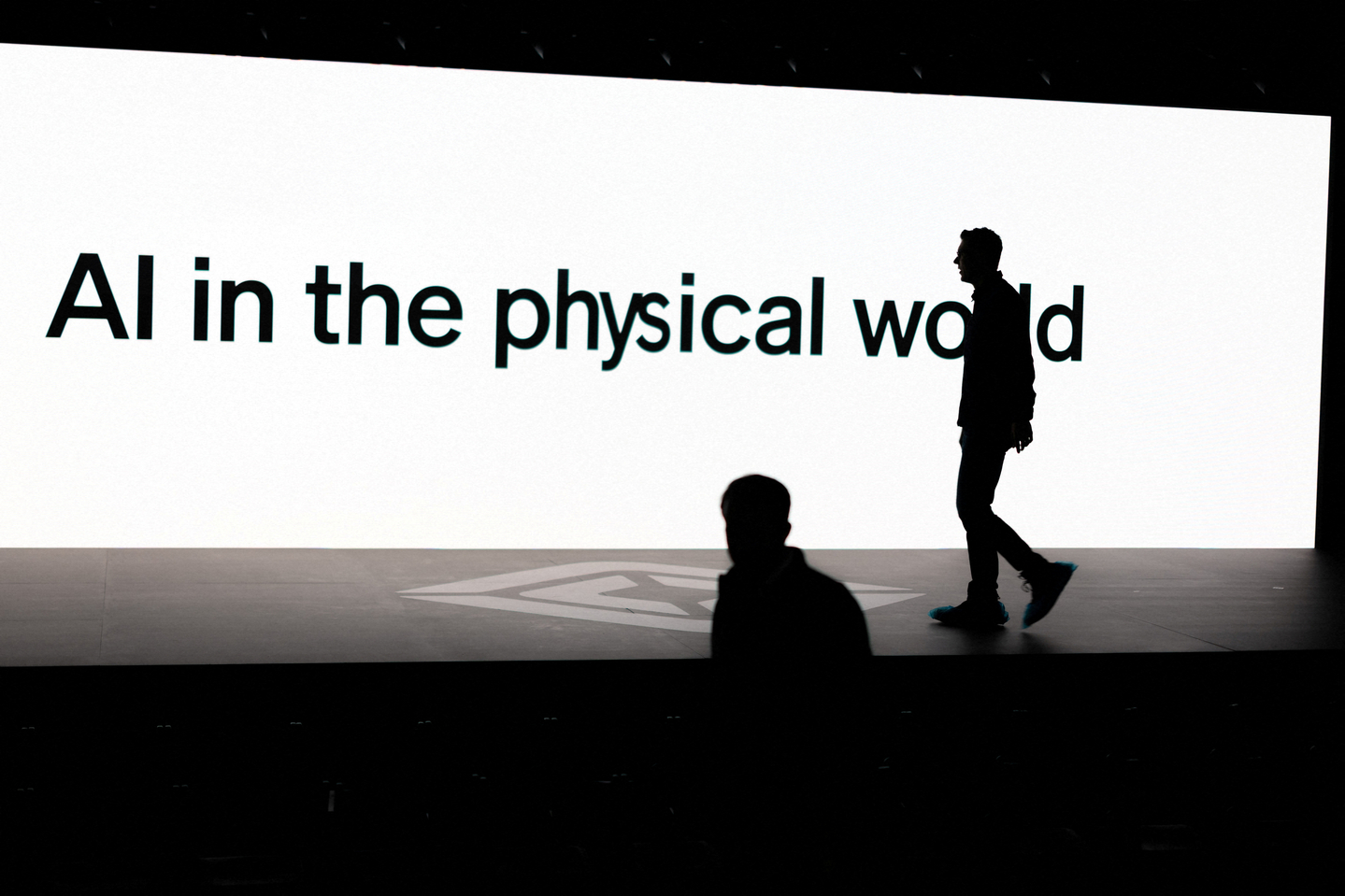 A screen reads "AI in the physical world" as attendees gather during Rivian's first Autonomy and AI Day, showcasing developments in self-driving technology, in Palo Alto, California, Dec. 11, 2025. [REUTERS/YONHAP]
