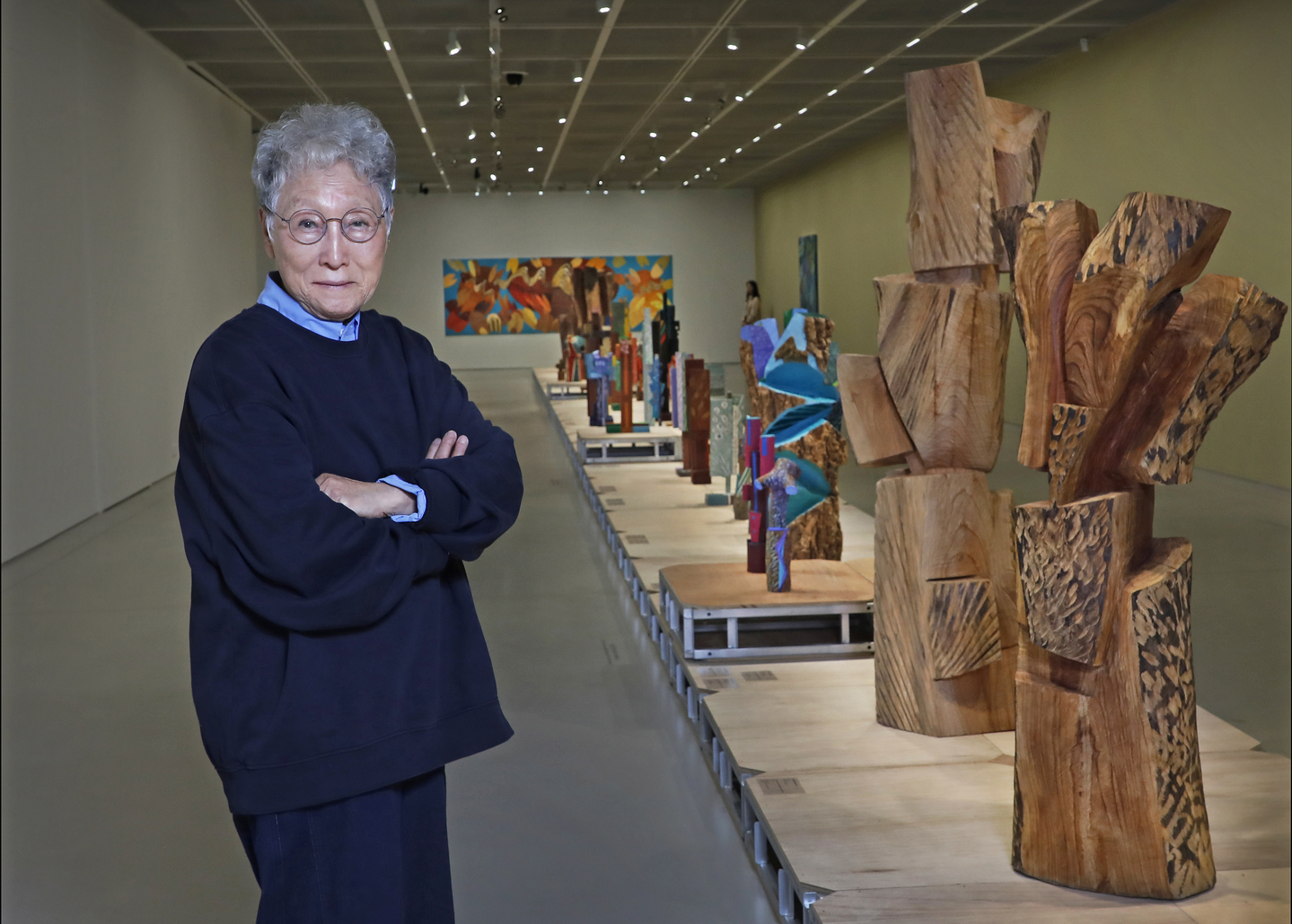 Kim Yun-shin poses for a photo with her sculptures displayed at her ongoing retrospective "Two Be One" at Hoam Museum of Art in Yongin, Gyeonggi, on March 13. [PARK SANG-MOON]