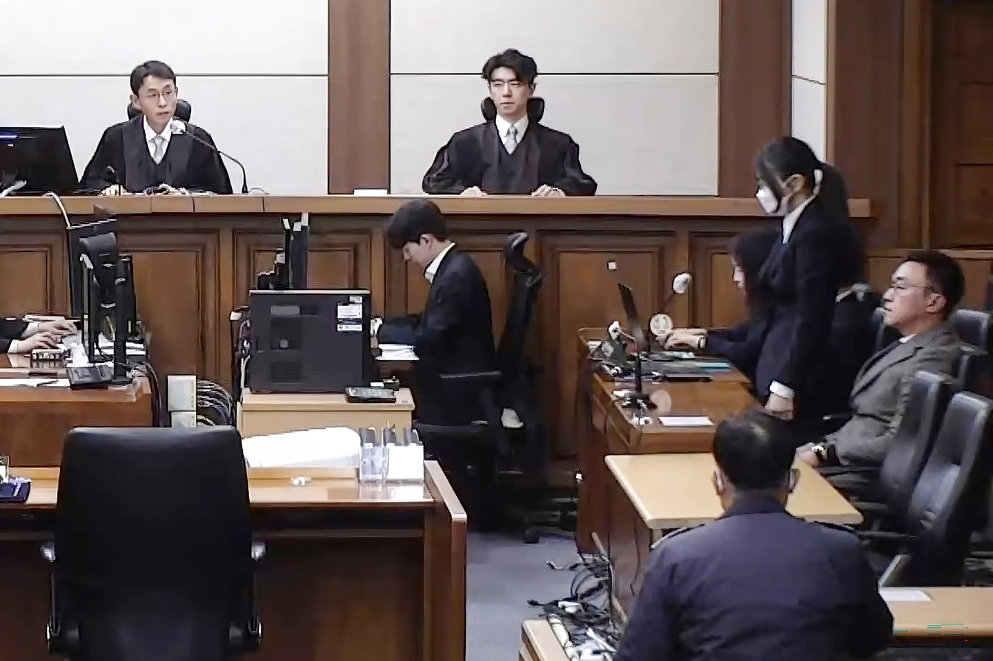 Former first lady Kim Keon Hee, second from right, listens to a verdict during a sentencing hearing on charges of bribery, stock price manipulation and political interference at the Seoul Central District Court in Seocho District, southern Seoul, on Jan. 28 in this footage streamed live by the court. [SCREEN CAPTURE]