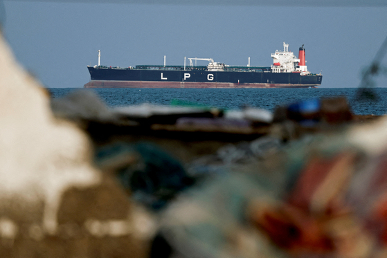 An liquefied natural gas tanker at anchor is seen as traffic is down in the Strait of Hormuz, amid the U.S.-Israeli conflict with Iran, in Shinas, Oman, on March 11. [REUTERS/YONHAP]