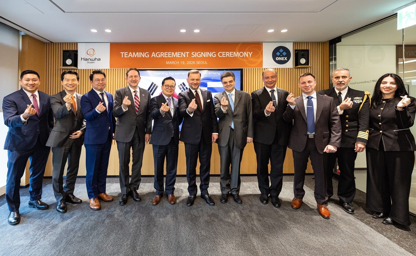 Hanwha Ocean signed a strategic teaming agreement with Onex Group on March 19 to cooperate on defense business in Greece. From fourth left: James Heller, the charge d’affaires at the U.S Embassy in Korea; Eo Sung-cheol, head of Hanwha Ocean’s special ship business unit; Panagiotis Xenokostas, CEO of Onex Group; and Loukas Tsokos, Greece’s ambassador to Korea, pose for a photo after the signing ceremony held at Hanwha Ocean's office in central Seoul on March 19. [HANWHA OCEAN]