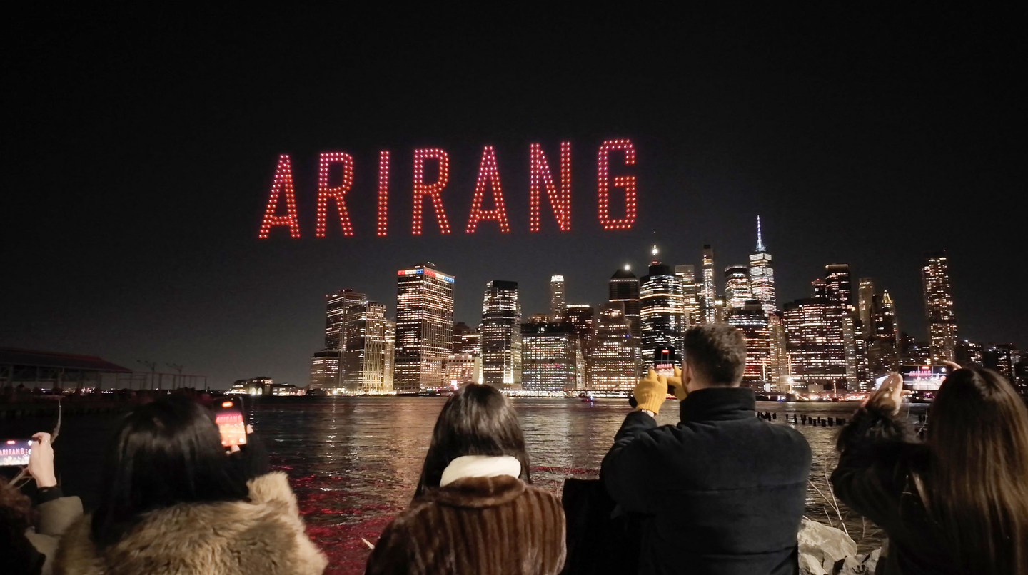 A drone light show is on display over the Brooklyn Bridge in New York on March 18 to mark the long-awaited return of boy band BTS. [BIGHIT MUSIC]