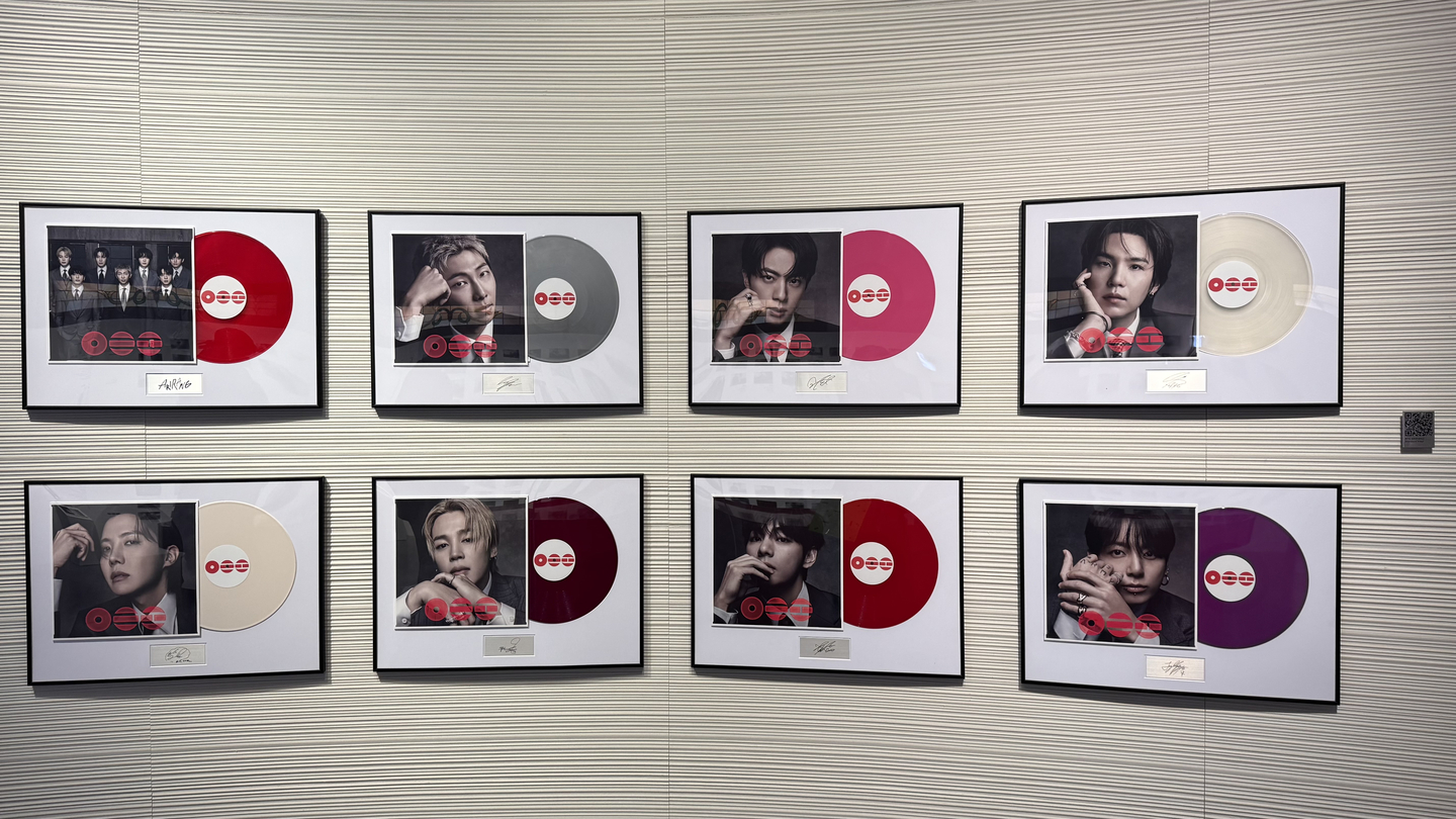 A wall displays LPs in different colors paired with portraits of each member at the BTS pop-up store on the fourth floor of The Heritage at Shinsegae The Main in Jung District, central Seoul. [WOO JI-WON]
