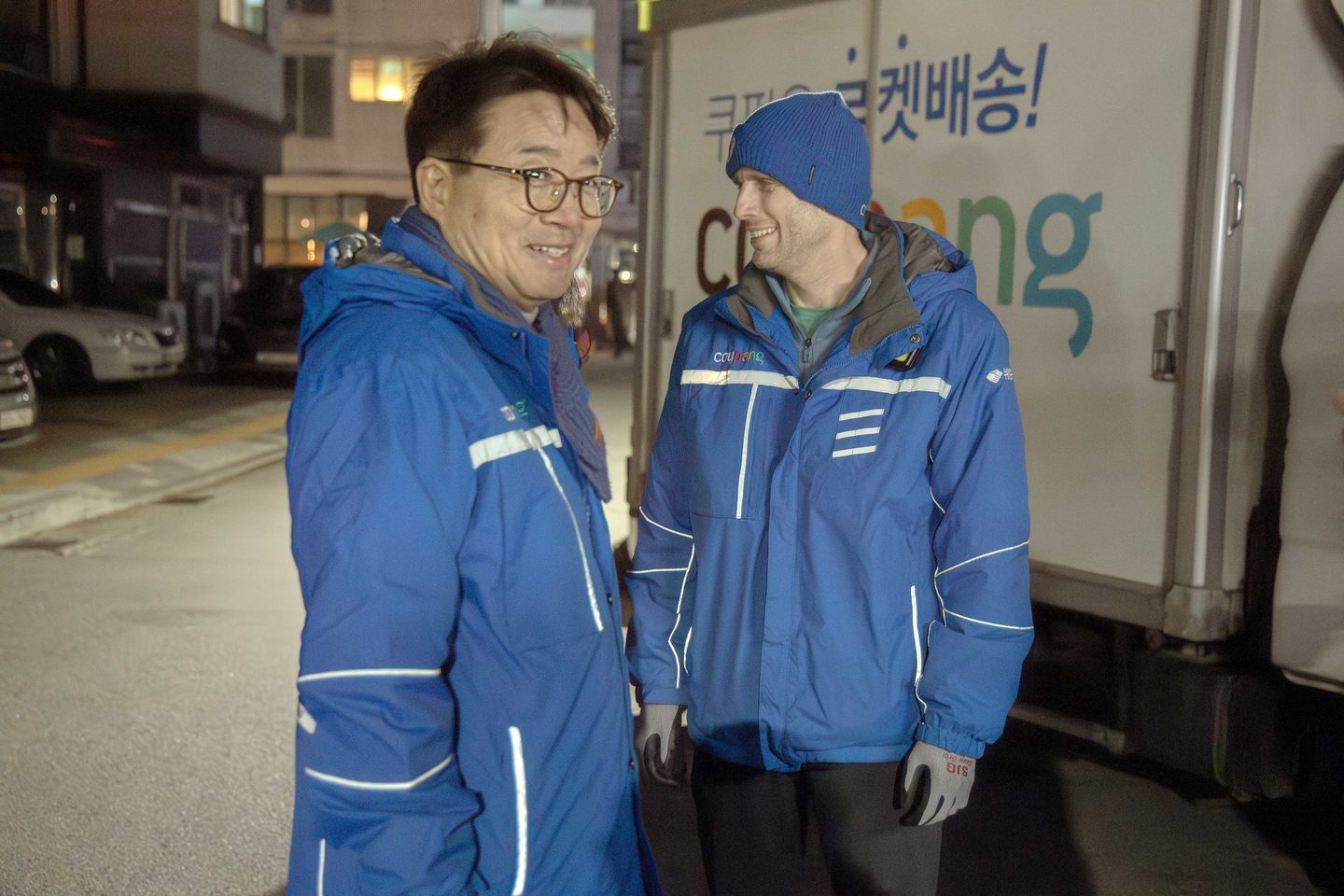 Coupang interim CEO Harold Rogers, right, and Democratic Party lawmaker Yeom Tae-young take part in the e-commerce company's dawn delivery work from the evening of March 19 to the next morning, as part of the CEO's promise to take a closer look at the working conditions of the company's delivery workers. [COUPANG]