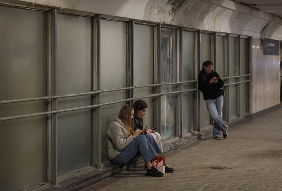 People take shelter inside an underground passage during Russian missile and drone strike on Kyiv, Ukraine, on March 16. [REUTERS/YONHAP]
