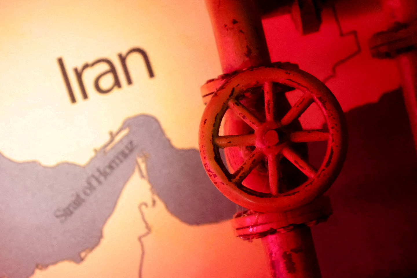 A map showing the Strait of Hormuz and Iran is seen behind a 3D printed oil pipeline in this illustration taken on June 22, 2025. [REUTERS/YONHAP]