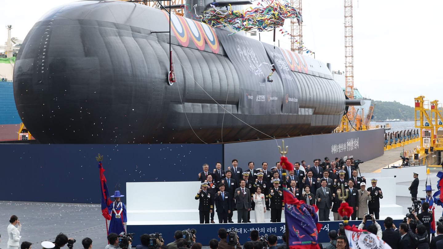 Officials pose for a photo during the launch ceremony of the Jang Yeong-sil submarine made by Hanwha Ocean, in Geoje, South Gyeongsang, on Oct. 22, 2025. [YONHAP]