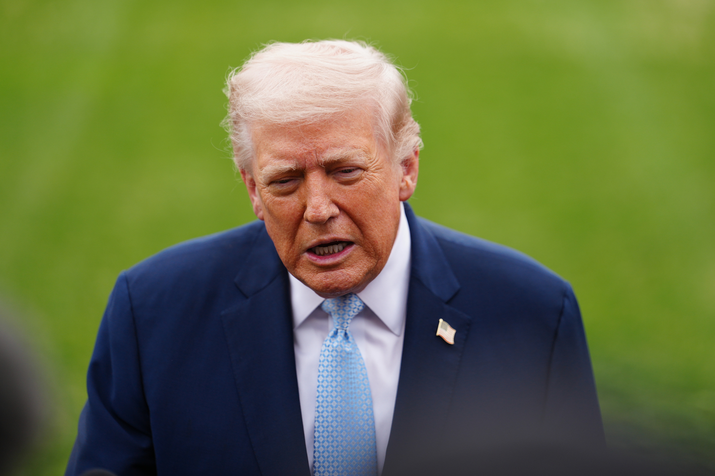 President Donald Trump speaks with reporters before departing on Marine One from the South Lawn of the White House, on March 20, in Washington. [AP/YONHAP]