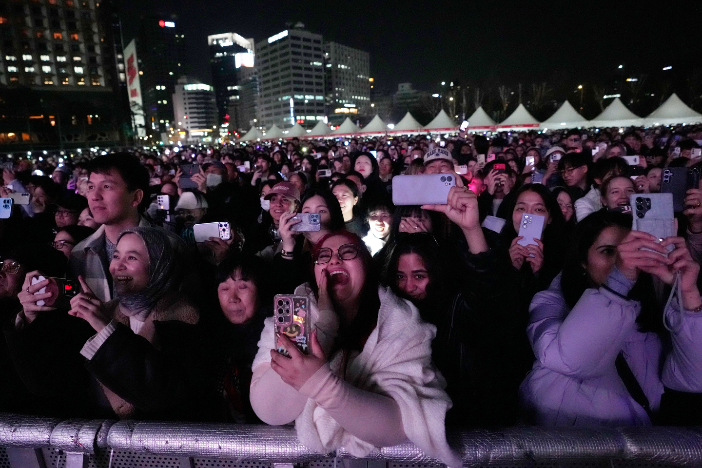 Fans cheer and hold mobile phones to capture moments from boy band BTS's comeback performance at Gwanghwamun Square in central Seoul on March 21. [AP PHOTO/YONHAP]