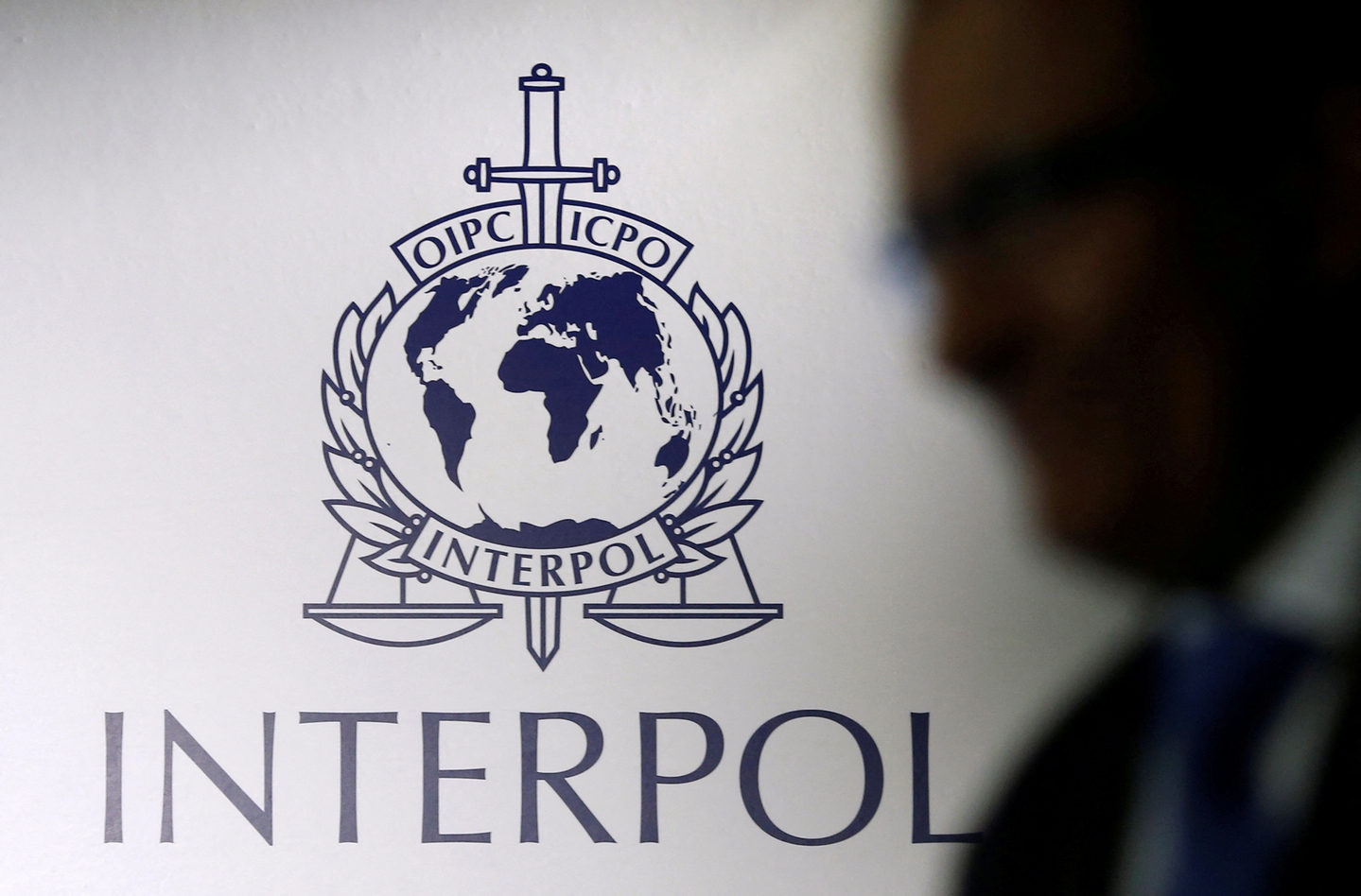 A man passes an Interpol logo in Singapore on Sept. 30, 2014, in this file photo unrelated to the story. [REUTERS/YONHAP] 