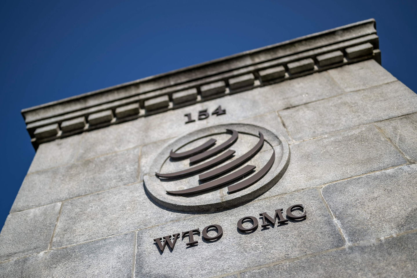 This photograph shows a sign of the World Trade Organization (WTO) at their headquarters after the launch of their global trade outlook in Geneva on March 19. [AFP/YONHAP]