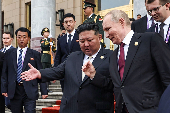 In this pool photograph distributed by the Russian state agency Sputnik, Russia's President Vladimir Putin, right, and North Korea's leader Kim Jong-un, center, leave after their meeting in Beijing, China, on September 3, 2025. [AFP/YONHAP]