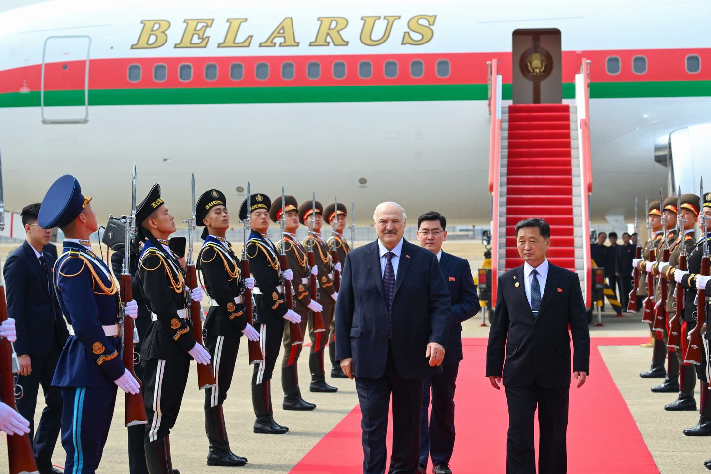 A handout photo made available by the Belarusian presidential press service shows Belarusian President Alexander Lukashenko, center left, walking during a welcome ceremony upon his arrival at Sunan International Airport in Pyongyang on March 25. [EPA/YONHAP]