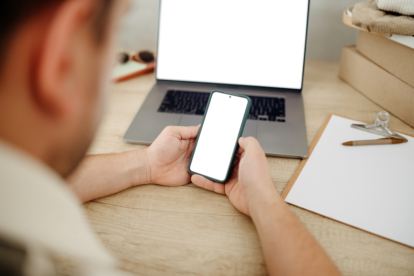 A man uses a mobile phone with a white background. [GETTY IMAGES PRO]