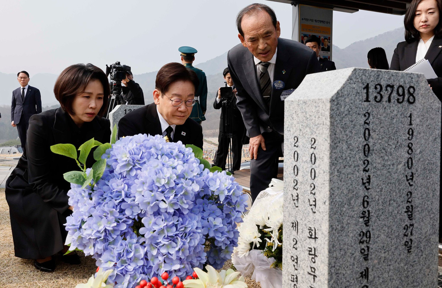 President Lee Jae Myung, second from left, and Kim Hea Kyung, left, pay tribute at the cemetery for those killed in the Second Battle of Yeonpyeong and the shelling of Yeonpyeong ahead of the 11th West Sea Defense Day ceremony at Daejeon National Cemetery on March 27. [JOINT PRESS CORPS]