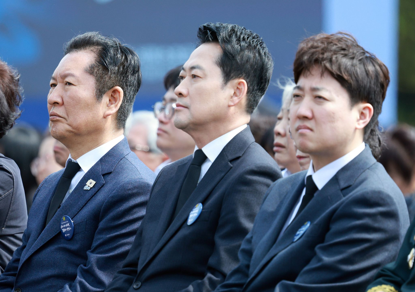 Democratic Party leader Jung Chung-rae, left, People Power Party leader Jang Dong-hyeok, center, and Reform Party leader Lee Jun-seok listen to President Lee Jae Myung’s commemorative remarks at the 11th West Sea Defense Day ceremony at Daejeon National Cemetery on March 27. [NEWS1]