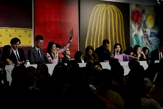 Christie‘s staff place in client bids via telephone during Christie’s Hong Kong 20th/21st Century Evening Sale at The Henderson in Central, Hong Kong, on March 27. [LEE JIAN]