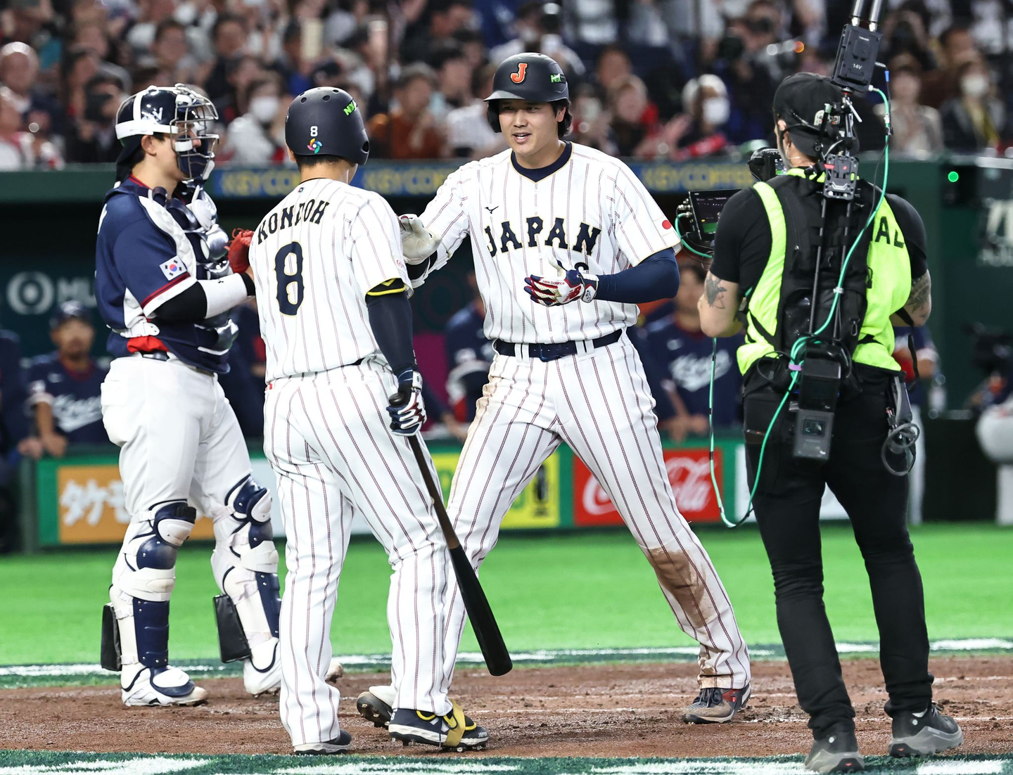 Japan’s Shohei Ohtani, center, celebrates after hitting a solo home run during the Group C game between Korea and Japan in the 2026 World Baseball Classic at Tokyo Dome in Tokyo on March 7. [YONHAP]