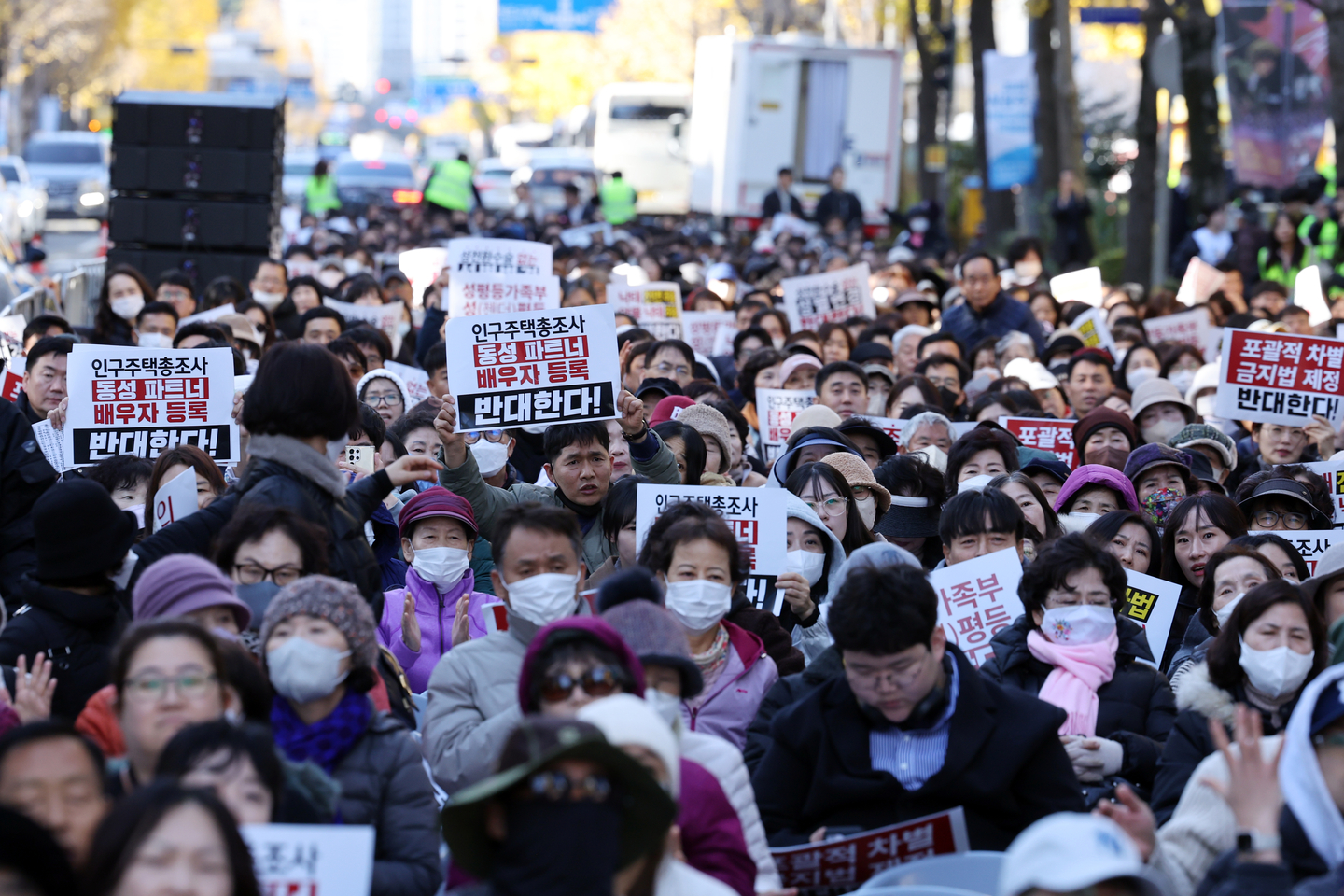 People hold up placards with slogans opposing the passage of a comprehensive antidiscrimination legislation at a conservative rally in Gwangju on Nov. 29, 2025. [YONHAP]