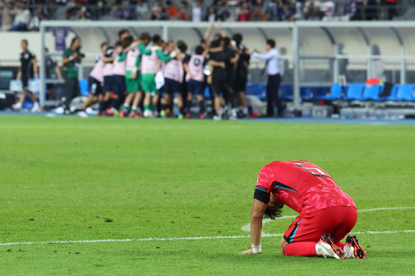 Korea defender Park Jin-seob kneels on the ground in disappointment after Korea loses 1-0 to Japan in the East Asian Cup in July 2025. [YONHAP]