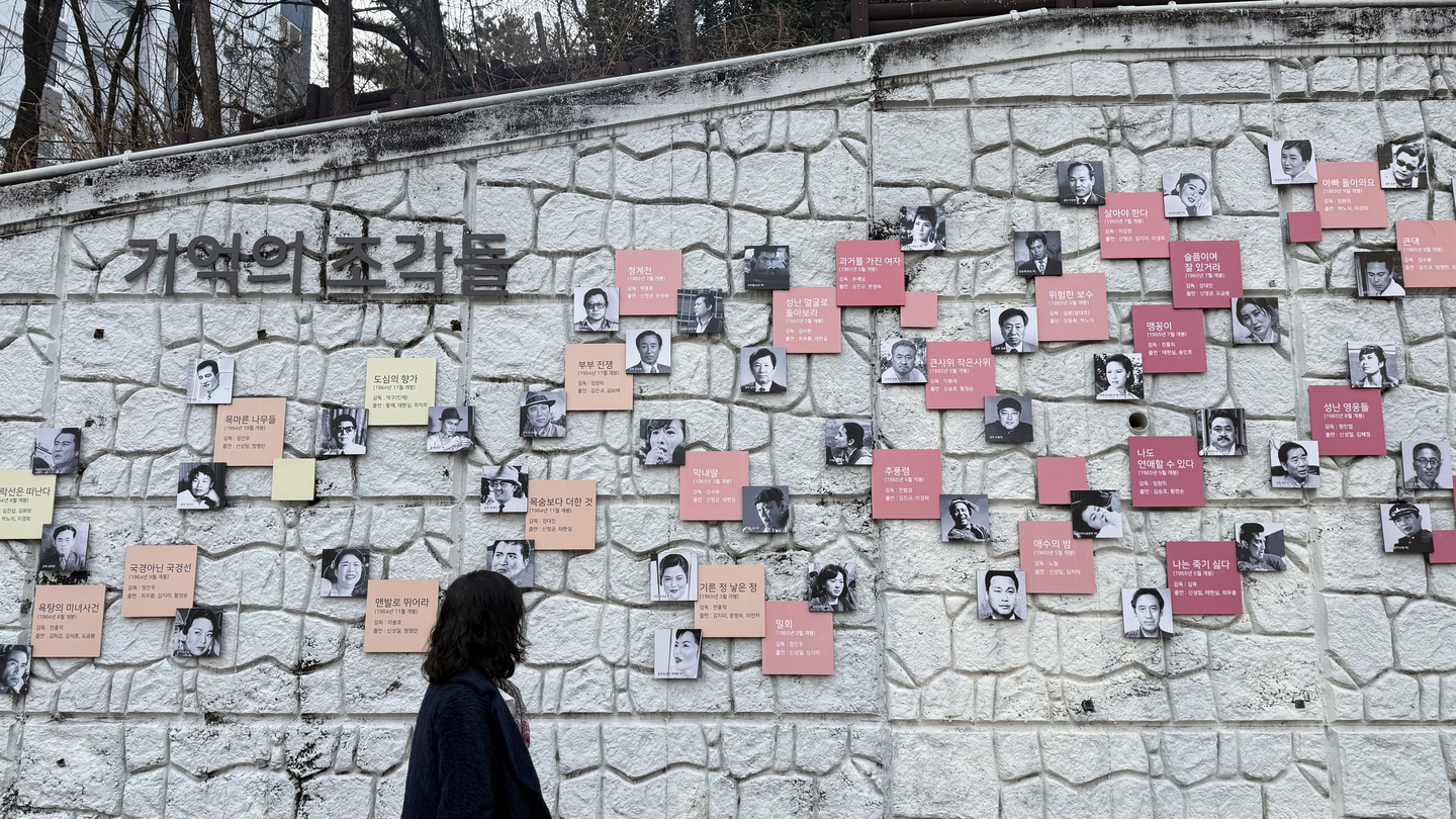 A person views murals on a wall. [WOO JI-WON]