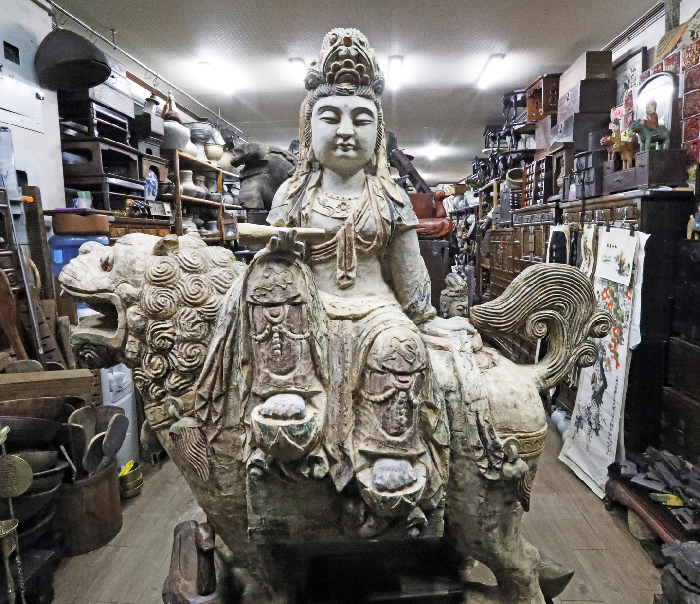 A stone sculpture of Buddha is placed inside a store at the Dapsimni Antique Shopping Mall on March 11. [PARK SANG-MOON]