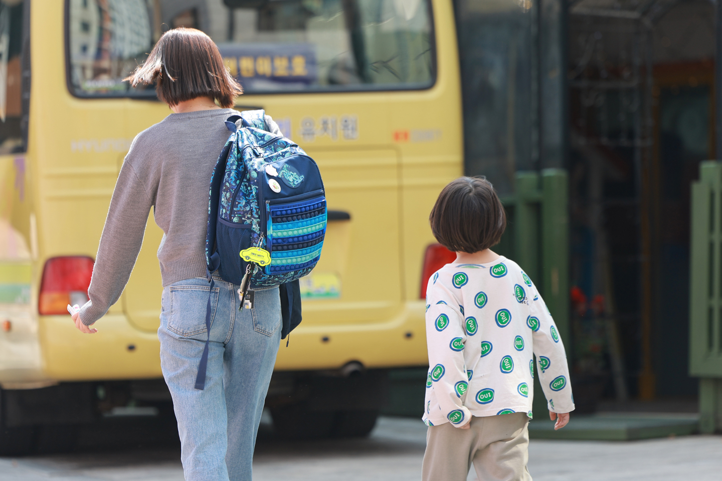 A child and a woman walk past a kindergarten in Gangnam District, southern Seoul, on April 7, 2025. [YONHAP] 