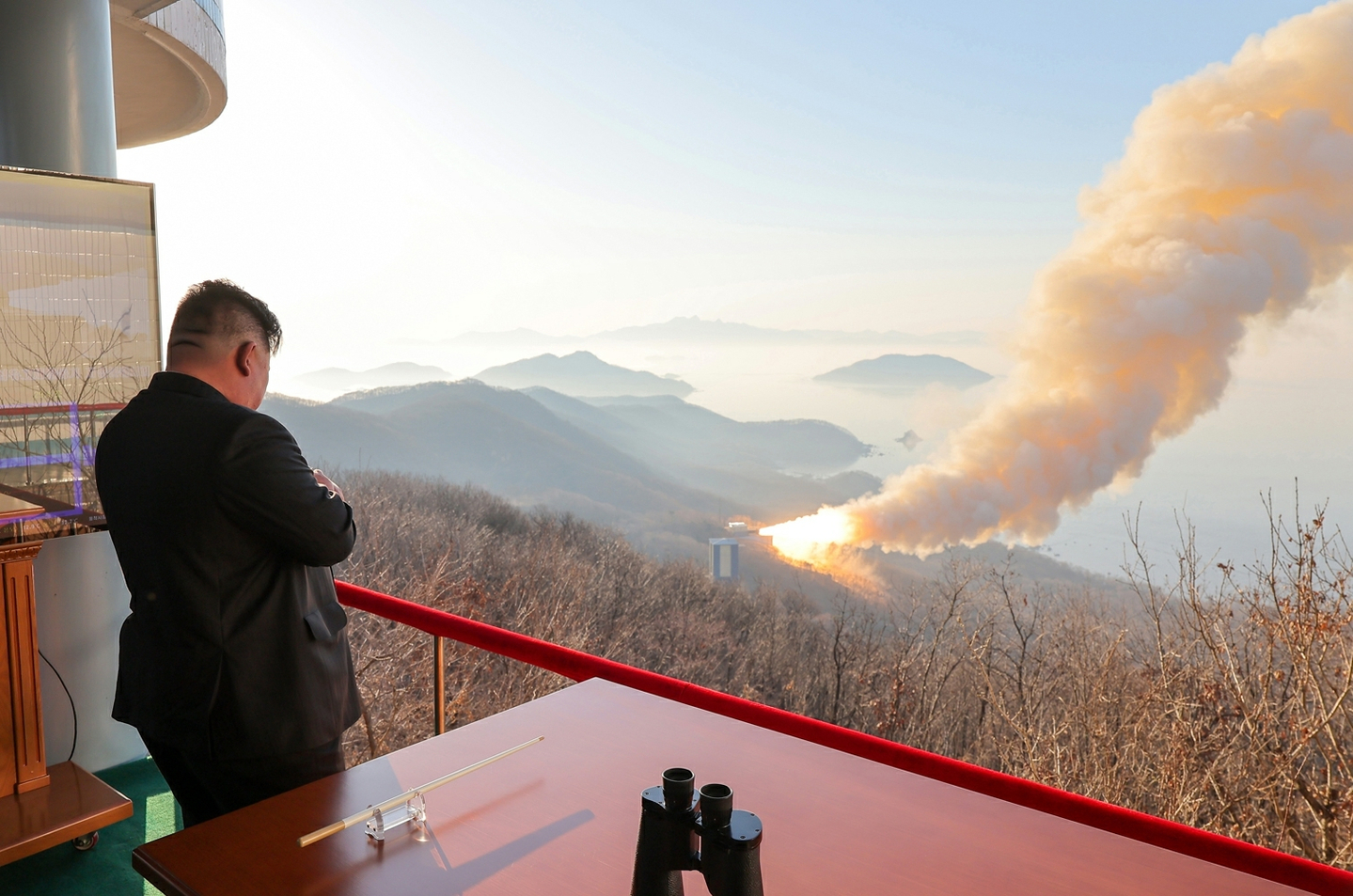 North Korean leader Kim Jong-un oversees a ground test of a high-thrust solid-fuel missile engine using a composite carbon fiber material in a photo shared on March 29. [NEWS1] 