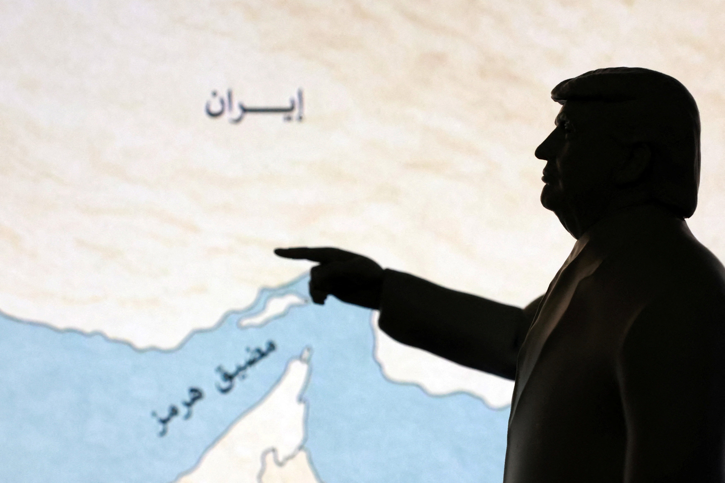 A 3D-printed miniature model depicting U.S. President Donald Trump and map showing the Strait of Hormuz, also known as Madiq Hurmuz, are seen in this illustration taken March 26, 2026. [REUTERS/YONHAP]