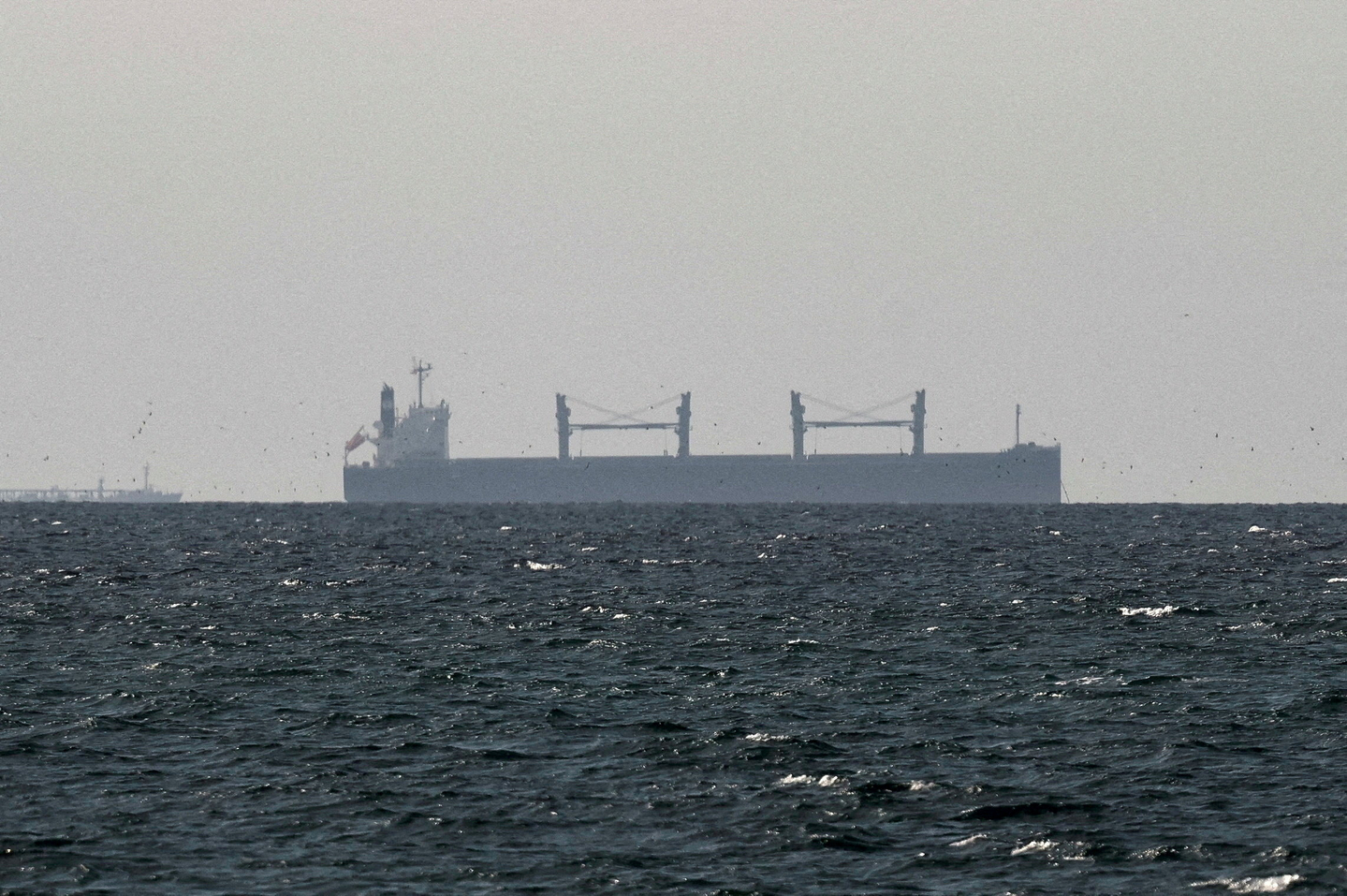 A cargo ship in the Gulf, near the Strait of Hormuz, is seen from northern Ras al-Khaimah, near the border with Oman’s Musandam governance, amid the U.S.-Israeli conflict with Iran, in United Arab Emirates, on March 11. [REUTERS/YONHAP]