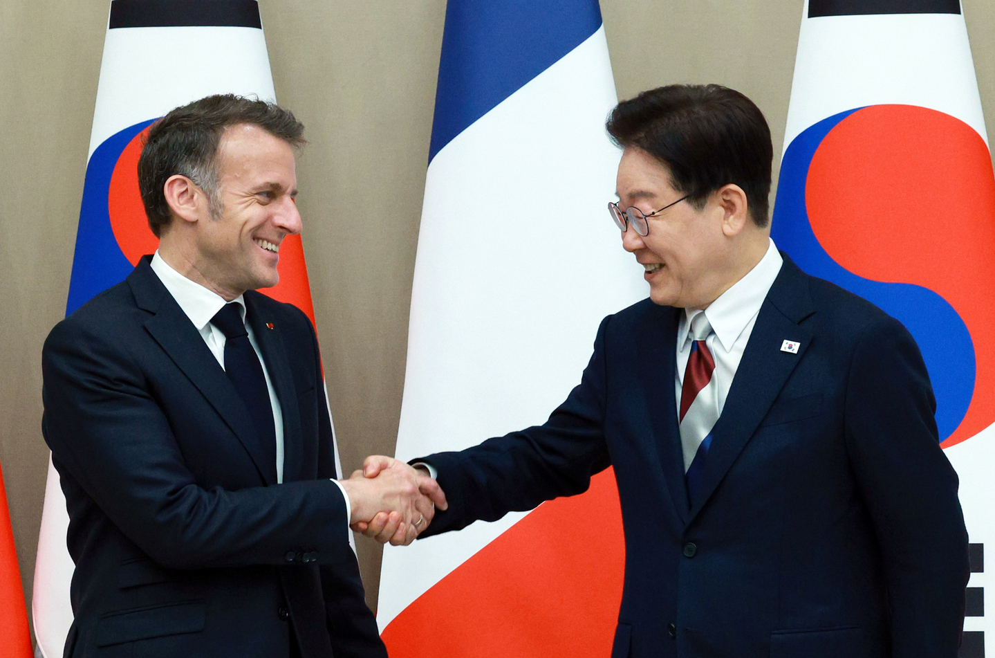 President Lee Jae Myung, right, shakes hands with French President Emmanuel Macron ahead of their bilateral summit at the Blue House in central Seoul on April 3. [JOINT PRESS CORPS]