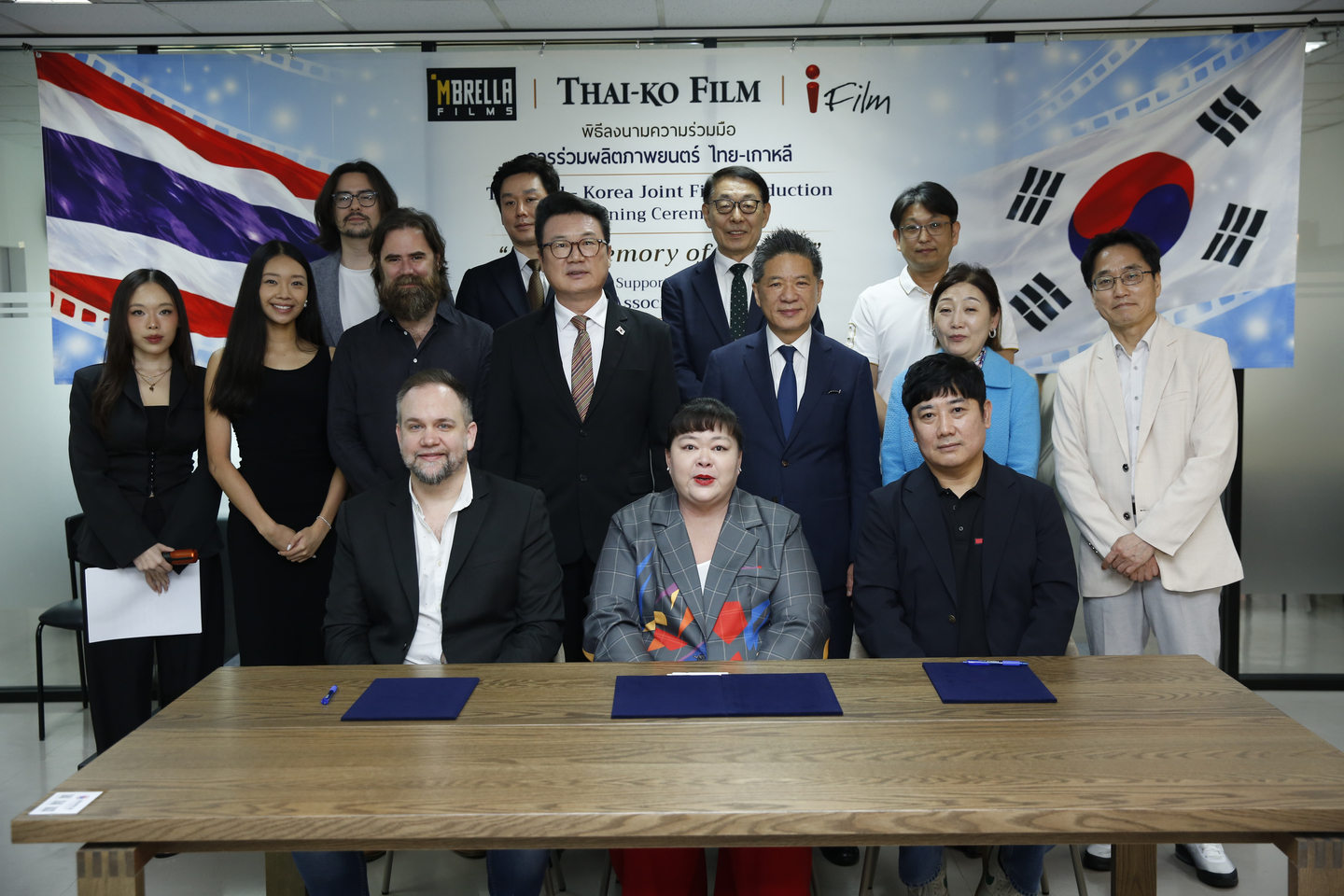 Executives from iFilm Corporation, Mbrella Films and ThaiKo Film pose for a photo after signing an agreement to produce "1950, Memory of the Day," a film about Thai soldiers who fought in the Korean War (1950-53), at the Sorachai Building in Bangkok, Thailand, on March 23. [IFILM CORPORATION]