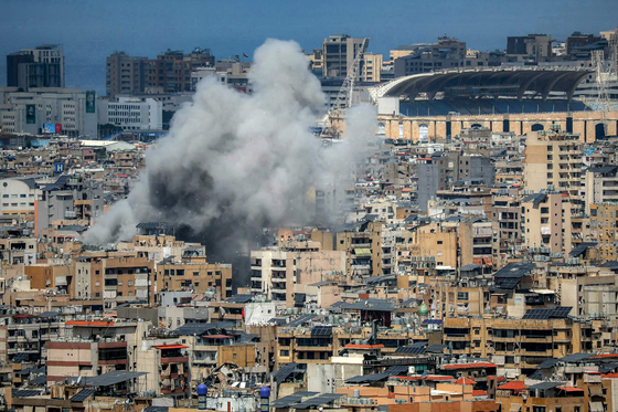 Smoke rises from the site of an Israeli strike in Beirut's southern suburbs, near Camille Chamoun Sports City Stadium on April 6. [AFP/YONHAP]