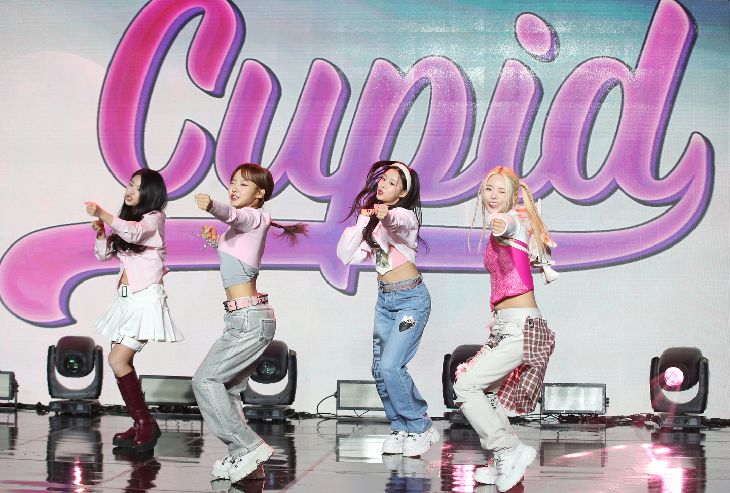 From left, girl group Fifty Fifty's current and past members Saena, Sio, Keena and Aran perform ″Cupid″ (2023) at a media conference at Gangnam District, southern Seoul, on April 13, 2023. [NEWS1] 