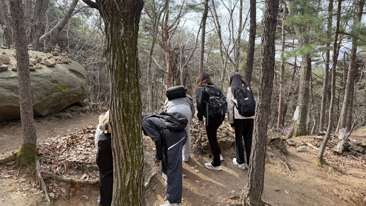 Hikers placing little stones on top of already-built stone carins [WOO JI-WON] [WOO JI-WON]