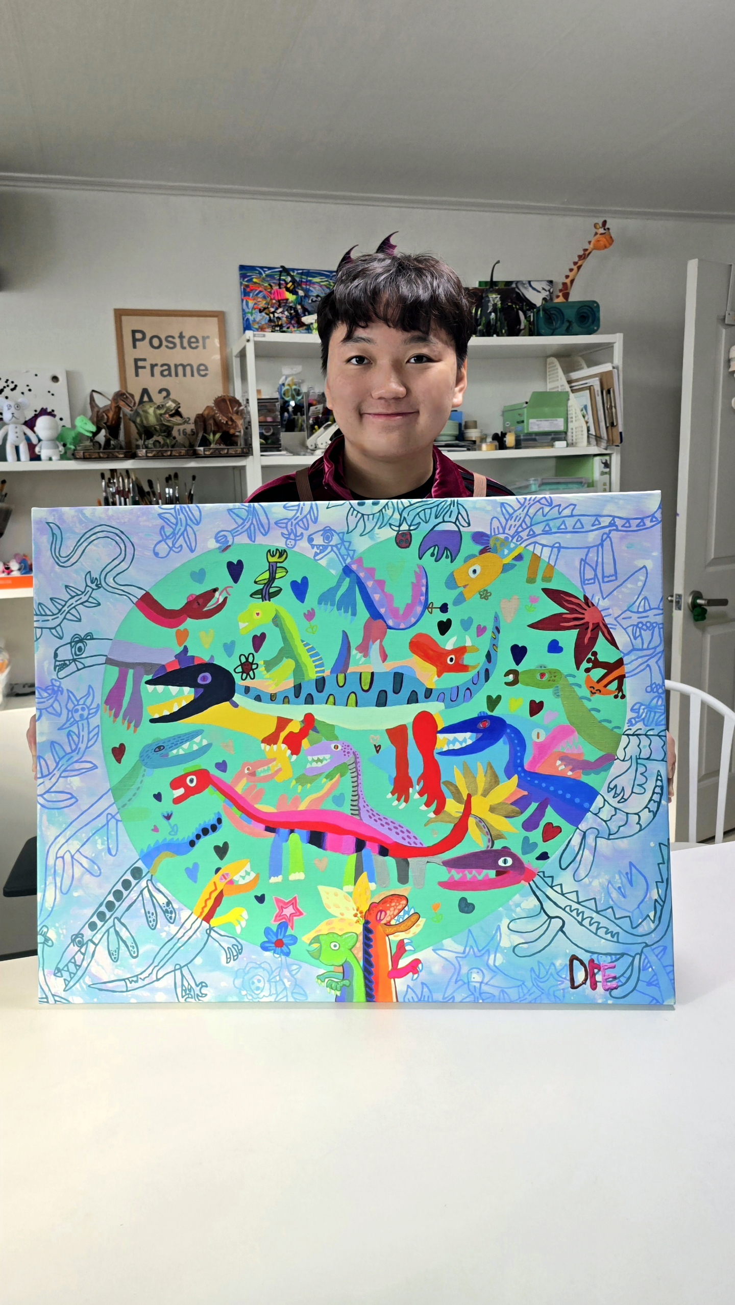 Artist An Dre shows his dinosaur painting. [AN DRE'S FAMILY]